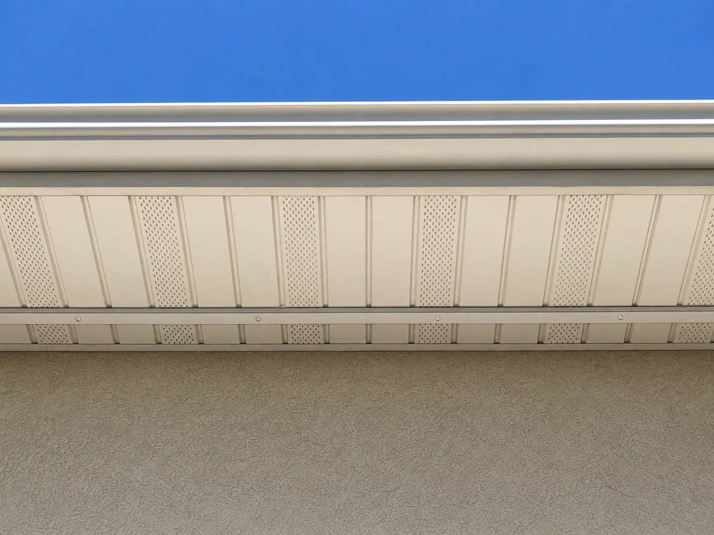Clean daytime lighting track detail along a residential roofline
